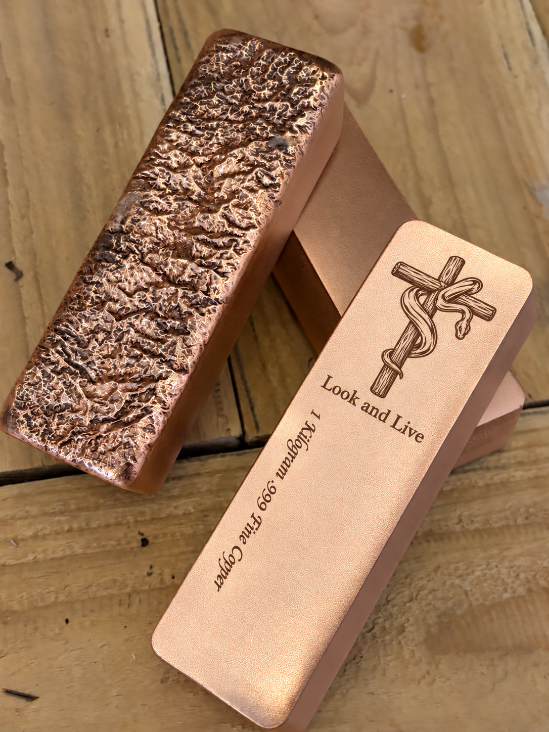 Look and Live 1 kilogram satin copper bar with engraved cross and serpent, front and rough cast reverse view