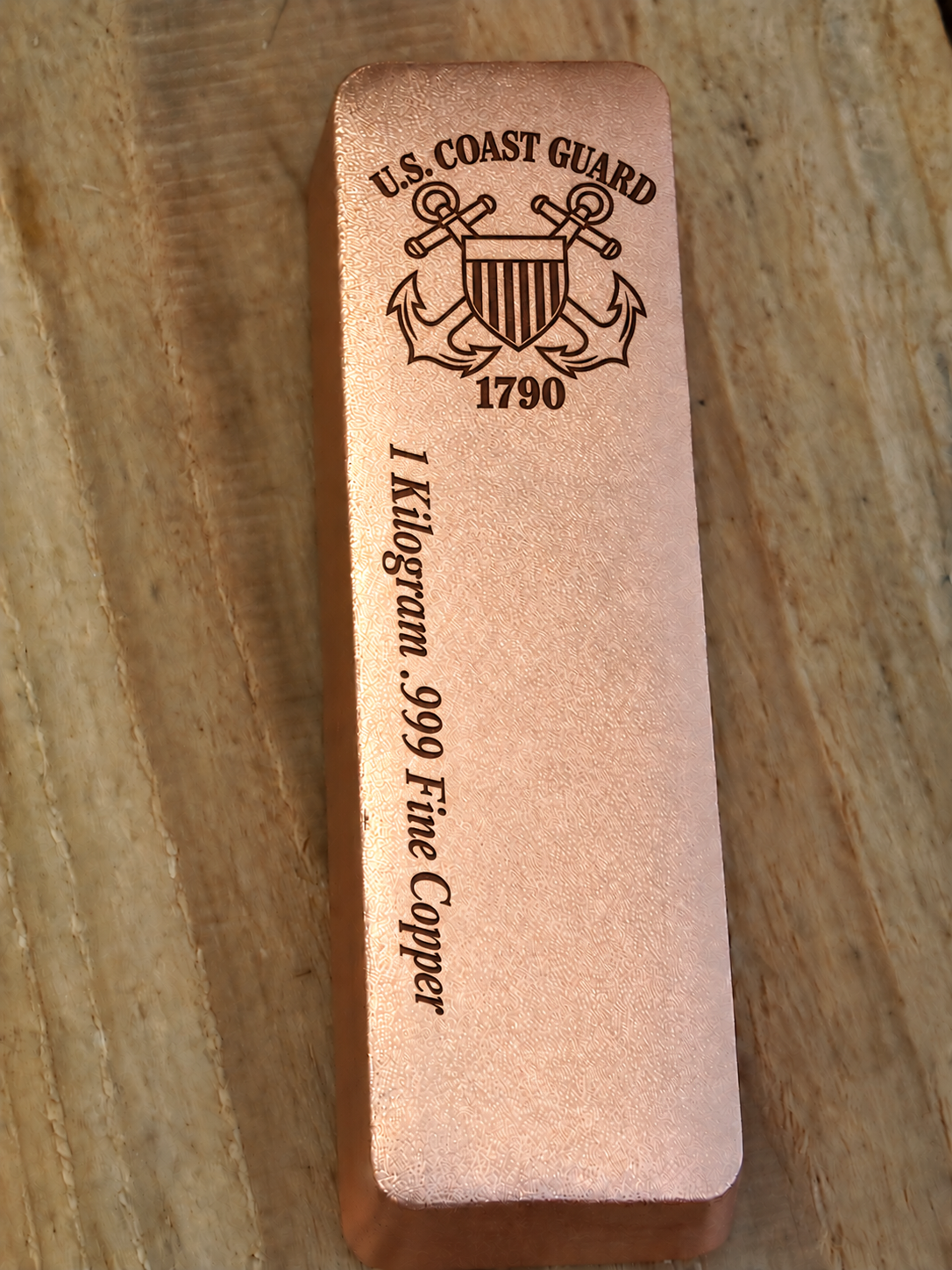 1 kilogram .999 fine copper Coast Guard bar in satin finish, front view, top emblem and lengthwise inscription