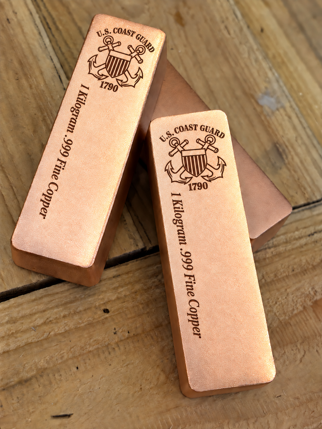 1 kilogram .999 fine copper Coast Guard bar in satin finish, angled stacked view, top emblem and lengthwise inscription