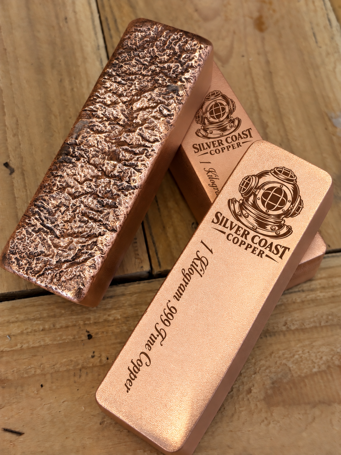 Diver's helmet 1 kilogram satin copper bars showing engraved fronts and rough cast reverse