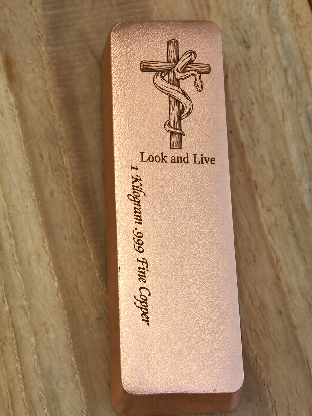 Look and Live 1 kilogram satin copper bar with engraved cross and serpent, front view
