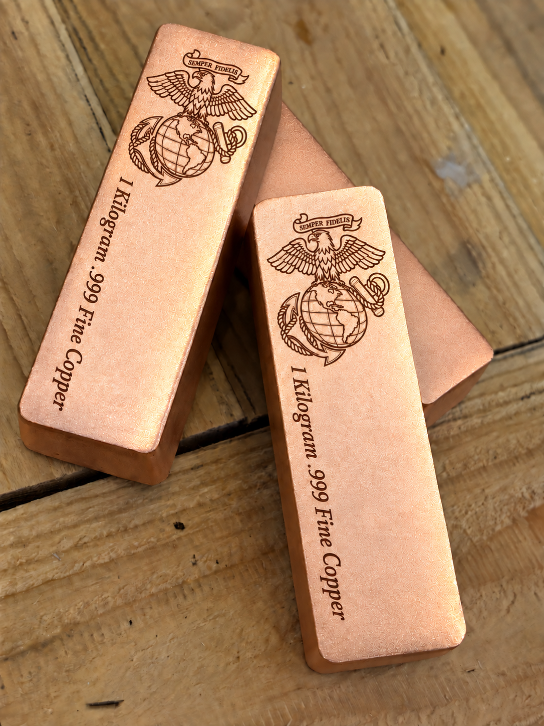 1 kilogram .999 fine copper Marine Corps bar in satin finish, angled stacked view, top emblem and lengthwise inscription