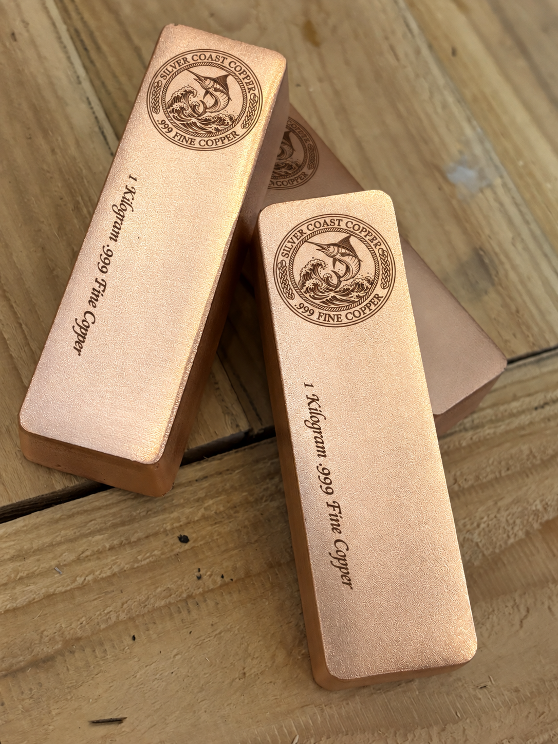 1 kilogram .999 fine copper marlin logo bar in satin finish - close angled view of stacked bars