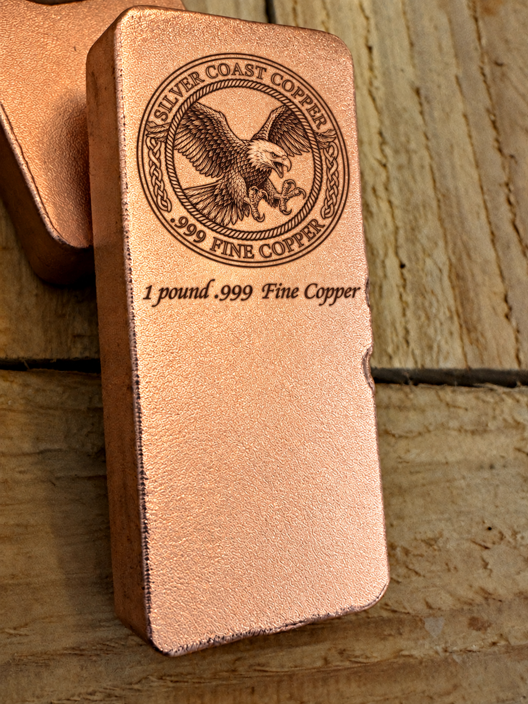 One pound .999 fine copper bar engraved with Silver Coast Copper eagle logo, angled view