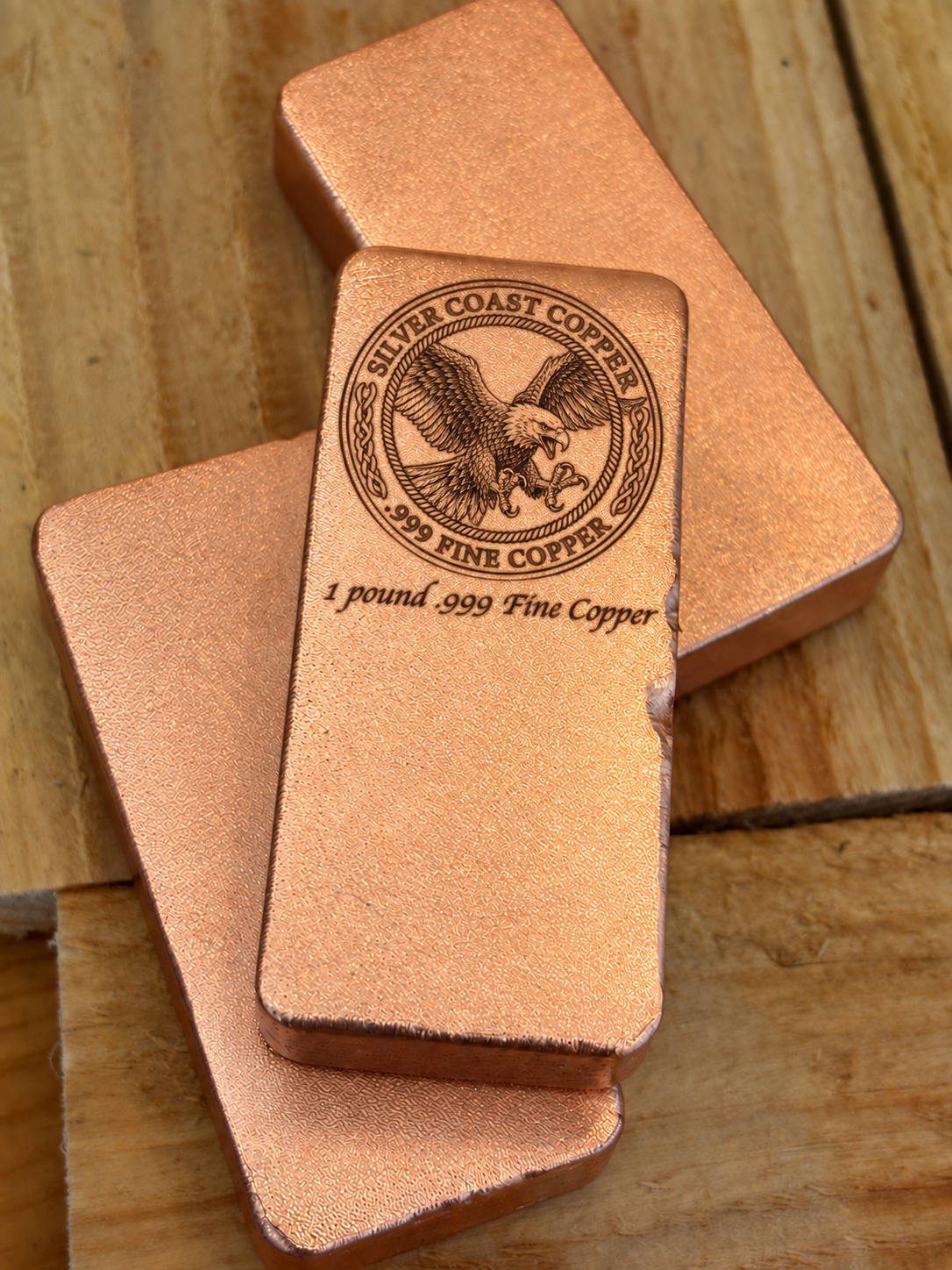 One pound .999 fine copper bar engraved with Silver Coast Copper eagle logo, stacked display