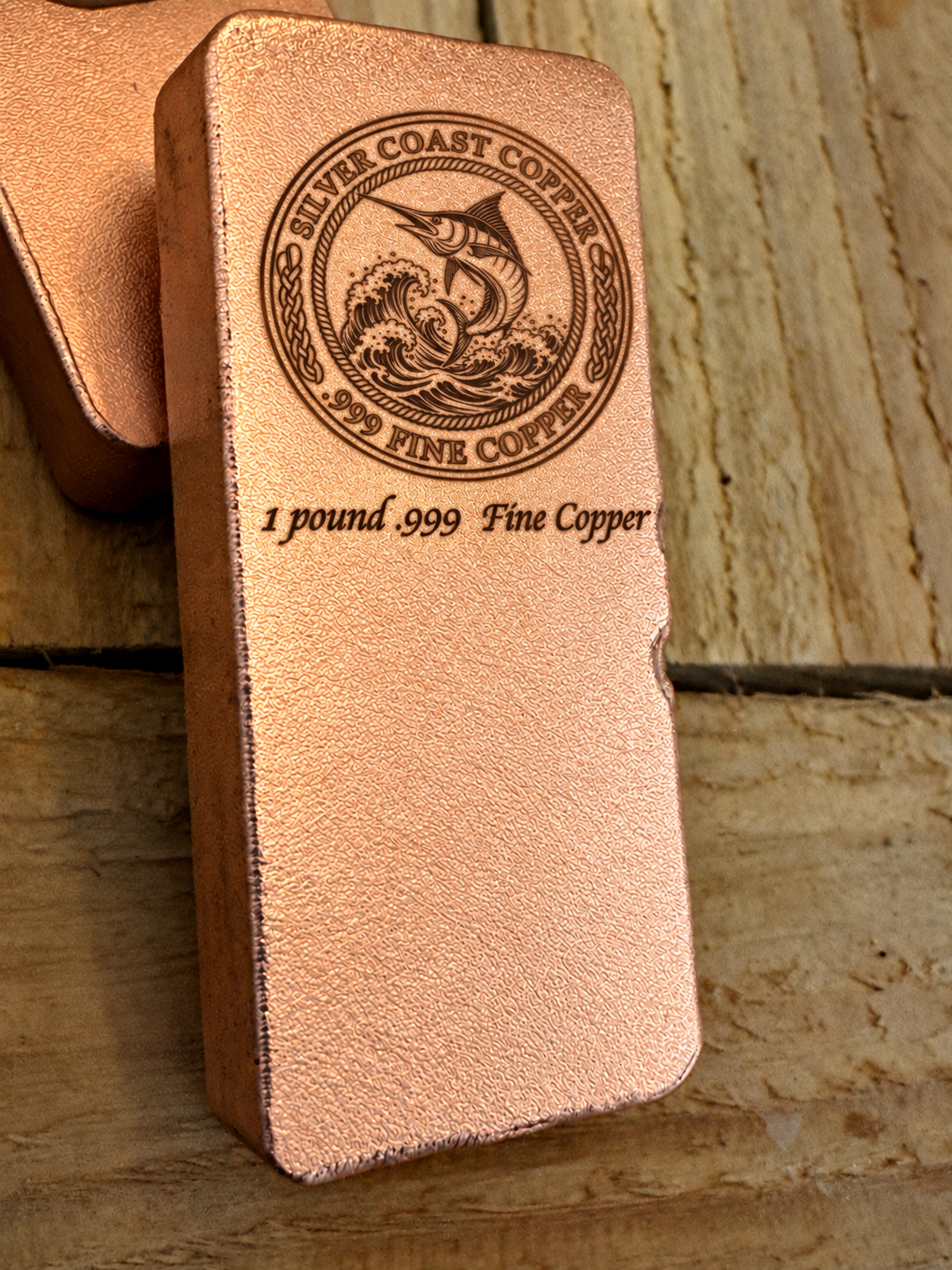 One pound .999 fine copper bar engraved with Silver Coast Copper Marlin logo, angled view