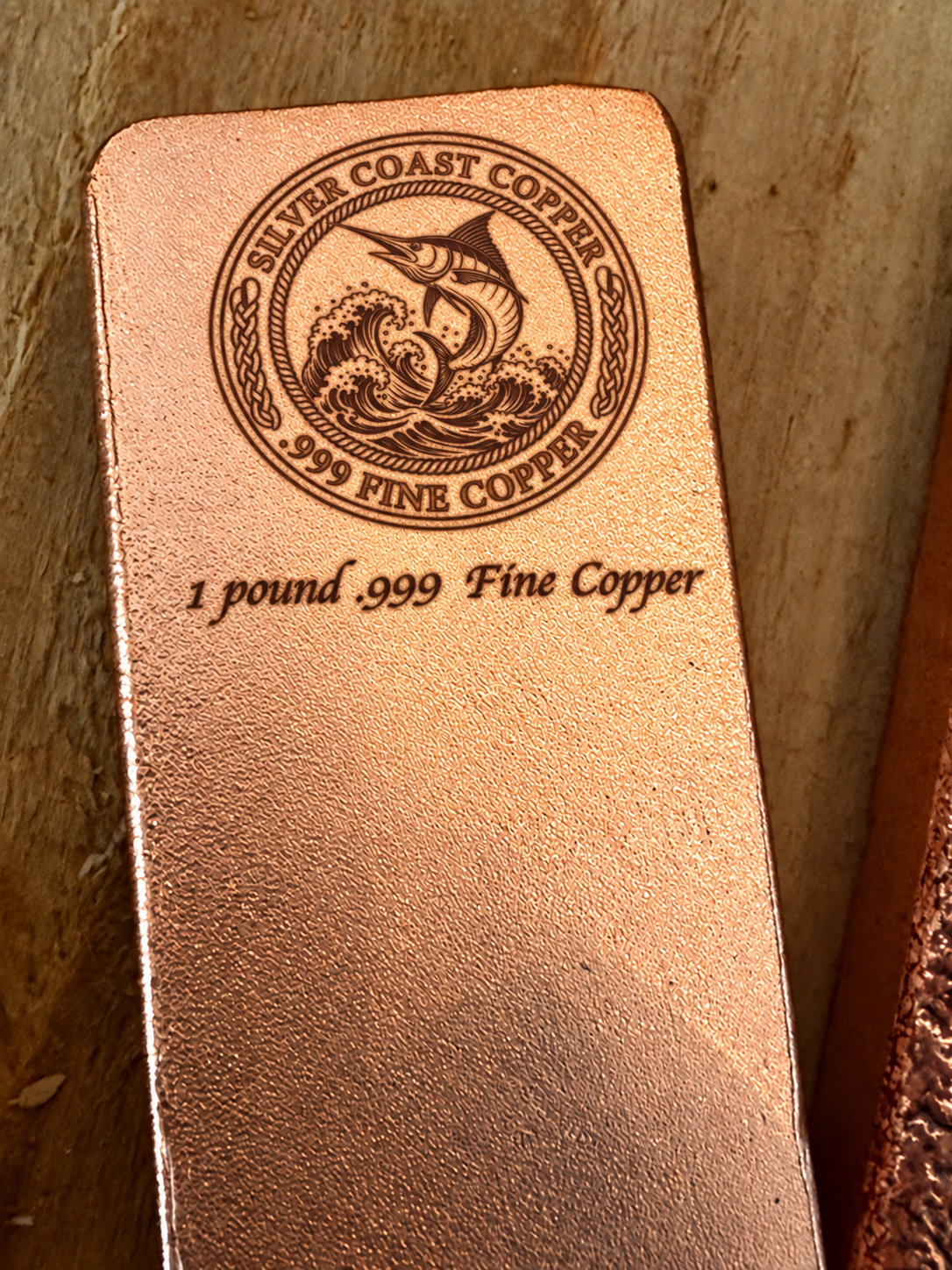 One pound .999 fine copper bar engraved with Silver Coast Copper Marlin logo, close-up view