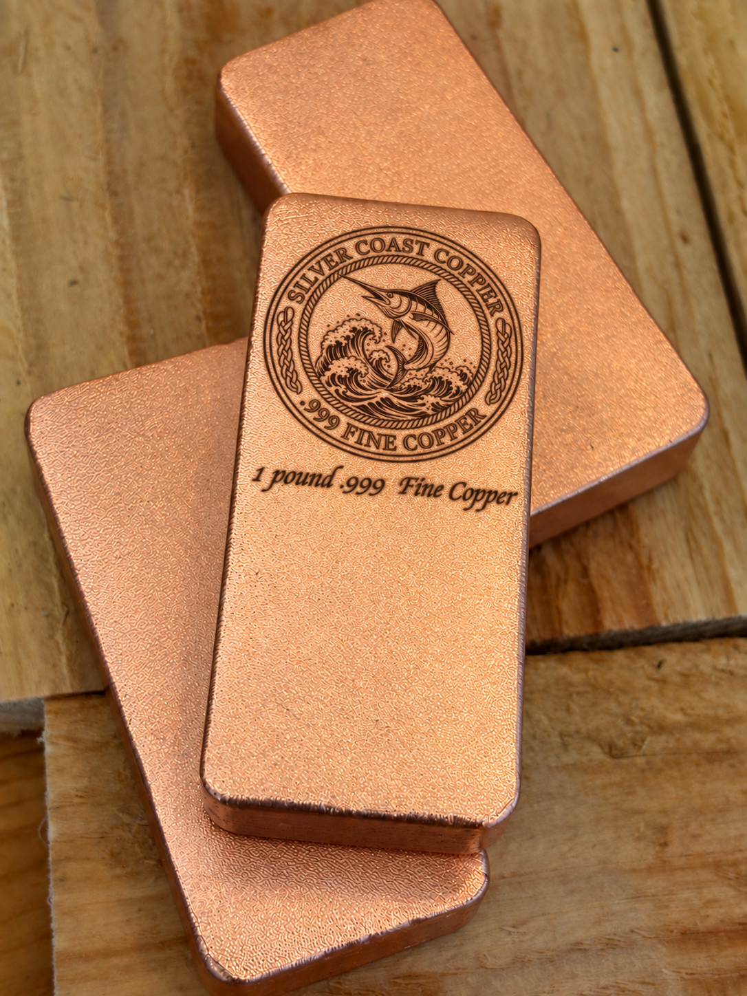 One pound .999 fine copper bar engraved with Silver Coast Copper Marlin logo, stacked display
