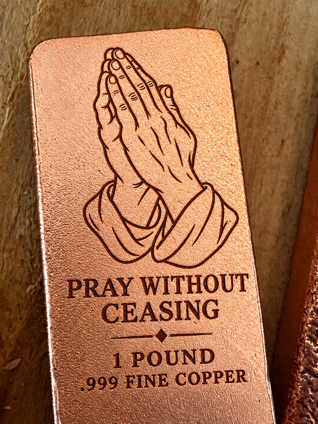 Praying Hands and "Pray Without Ceasing" engraved on a 1 pound .999 fine copper satin bar, close-up view (design preview)